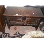 A 17th century style oak coffer with carved front