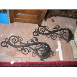 A pair of Rococo style cast iron garden wall pocke