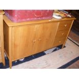 A light oak sideboard consisting of two door cupbo