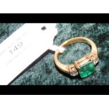 An emerald and diamond ring in 18ct setting