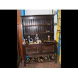 An oak dresser, rack to back, cupboards under - wi