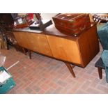 A mid century Utility sideboard with three drawers to cent