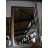 A large contemporary bevelled wall mirror in metal