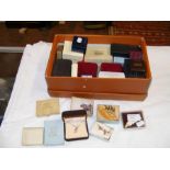 A box of costume jewellery including brooches etc.