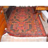 A Persian rug with geometric border and cen