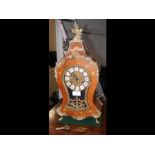 A French marquetry mantel clock - 48cms high