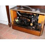 An old Singer sewing machine in travel case