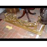 An antique brass fire fender, together with dogs a