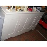 A cream painted kitchen side cabinet enclosed by t