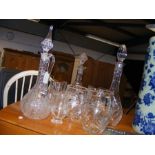 An assortment of cut glass decanters and jugs