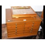 A multi-drawer collectors cabinet, together with a