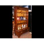 A mahogany open bookcase with drawer to the base