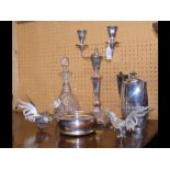 An elaborate candelabra, silver plated wine bottle