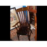 An antique slat back country armchair