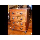 An antique four drawer collectors chest - 33cms hi