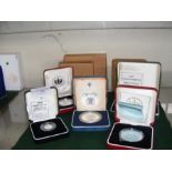 A selection of five boxed silver coins including T