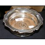A 17cm diameter silver wine bottle stand with Shef