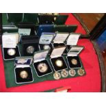 Nine boxed commemorative coins, together with four