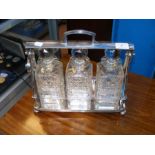 A three bottled silver plated tantalus
