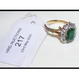An attractive baguette cut emerald and diamond rin