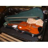 A violin with bow in fitted carrying case