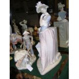 A large Lladro figurine of lady holding umbrella -