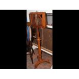 An antique style music stand with reeded column