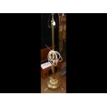 An adjustable antique brass standard lamp