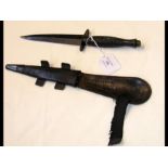 An old commando dagger with leather scabbard