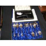 Silver tea spoons and sugar tongs in presentation