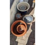 Six garden pots of varying shape and size