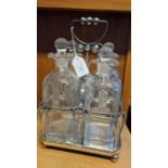 A silver plated and cut glass four bottle tantalus