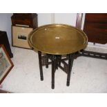 A 60cm diameter Middle Eastern brass top table
