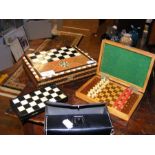 A travelling chess set and two others