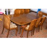 An Art Deco walnut extending dining table with the
