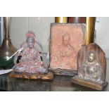 A cast metal buddha together with two others