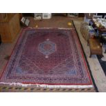 A Middle Eastern style carpet with geometric borde