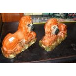 A pair of 34cm Staffordshire lion ornaments with g