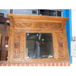 An profusely carved English oak over-mantel with c