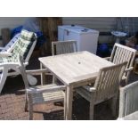 A teak 90cm square garden table with four matching