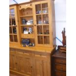 A pine dresser with two glazed cupboards above and