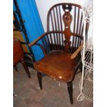 An antique elm stick back country chair with crino