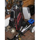 Four bags of golf clubs, together with a PowaKaddy