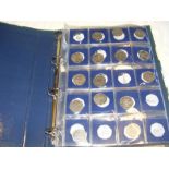 An album containing various collectable coinage in