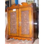 A carved oak smoker's cabinet