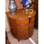 An unusual semi-circular mahogany drinks cabinet