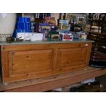 A panelled pine box with painted top and sides