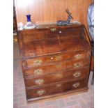 An antique fall front bureau with drawers below