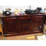 A mahogany sideboard with three drawers and three