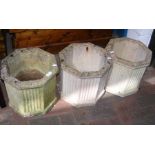 Three octagonal cast stoneware garden urns